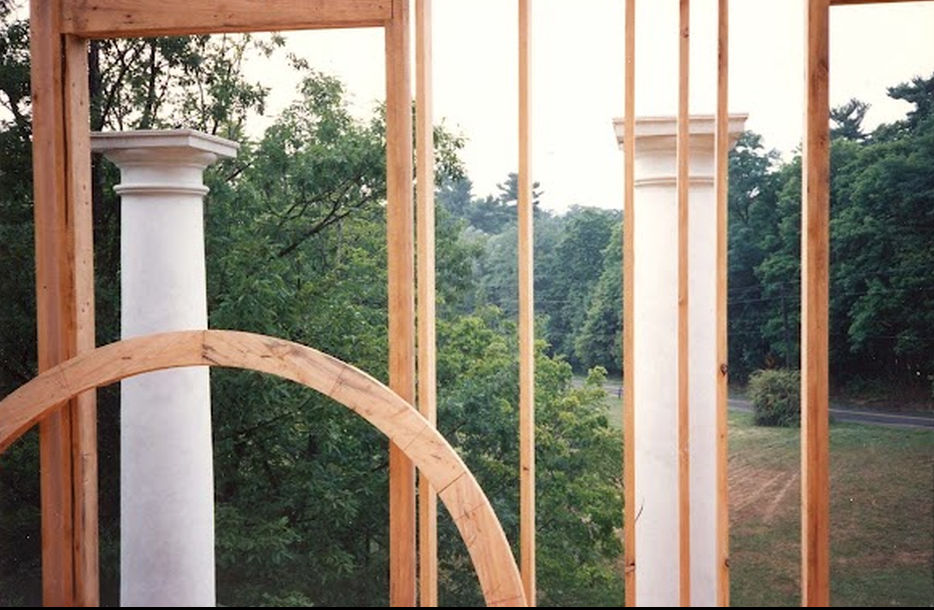 The columns with the arched basement openings visible below